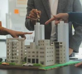 Real estate professionals reviewing a multifamily property model for investment and development planning
