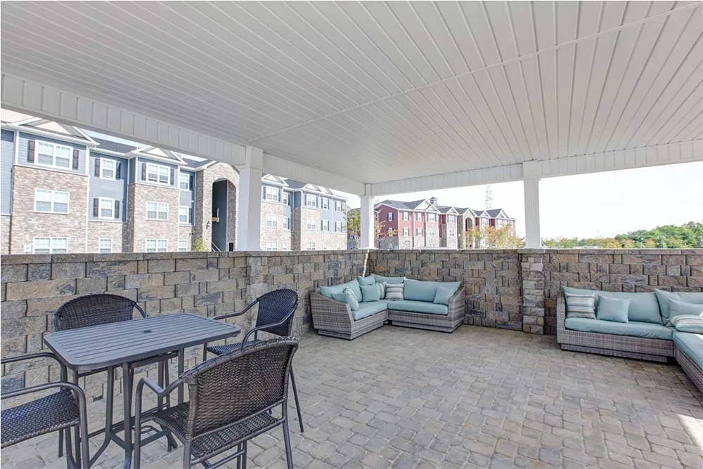 Covered outdoor lounge and seating area at a Fort Mill apartment community