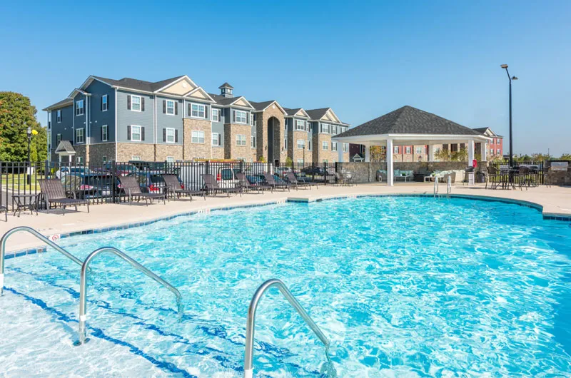 Outdoor swimming pool and apartment amenities at Villas at Regal Manor in Fort Mill